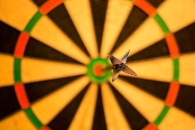Close-up image of a dart board with an arrow in the bullseye, representing Coash & Coash Court Reporting and Video’s advice for an accurate legal record.