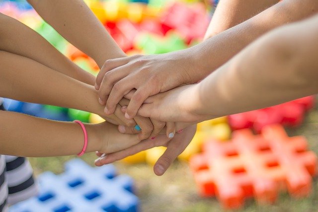 Image of children holding hands, representing the support Coash & Coash Court Reporting and Video provides to Arizona Helping Hands and other Arizona charities as part of its efforts to give back to the Arizona community.